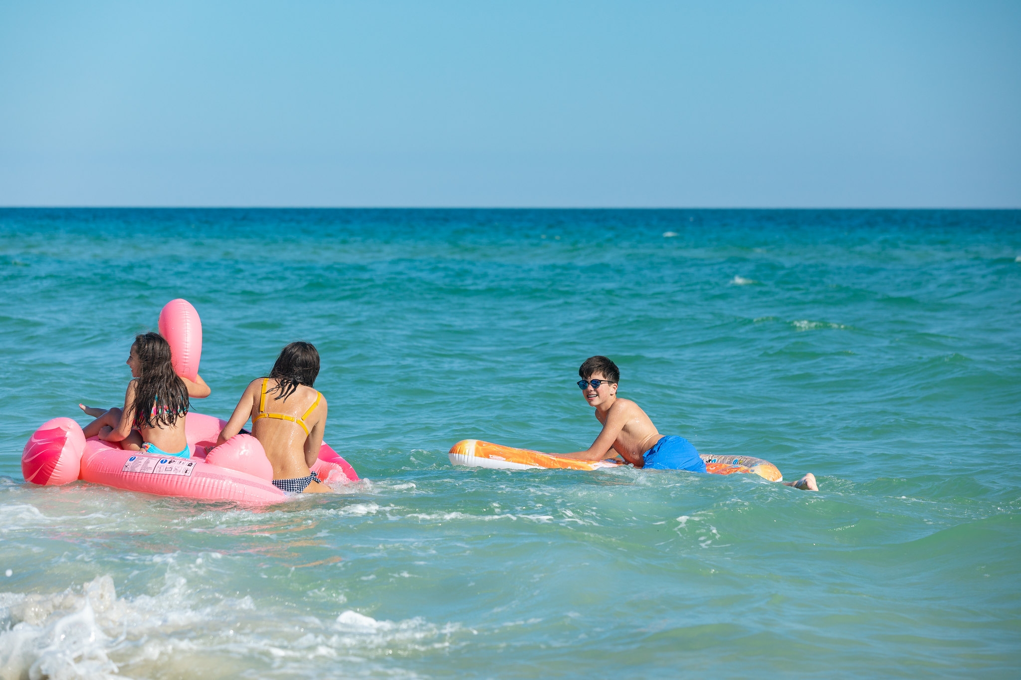 Families swimming and enjoying the beach on Alabama's Gulf Coast in Gulf Shores