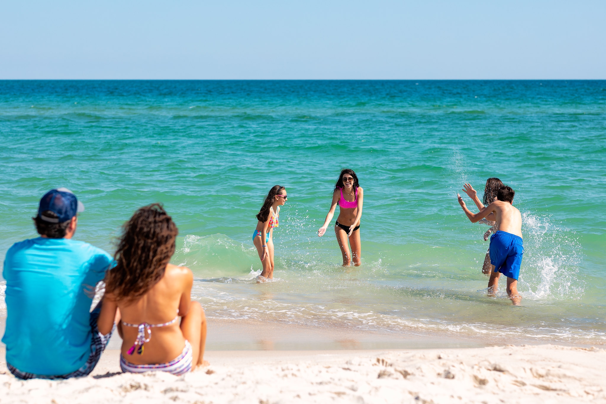 Families enjoying a summer beach trip on Alabama's Gulf Coast in Gulf Shores and Orange Beach
