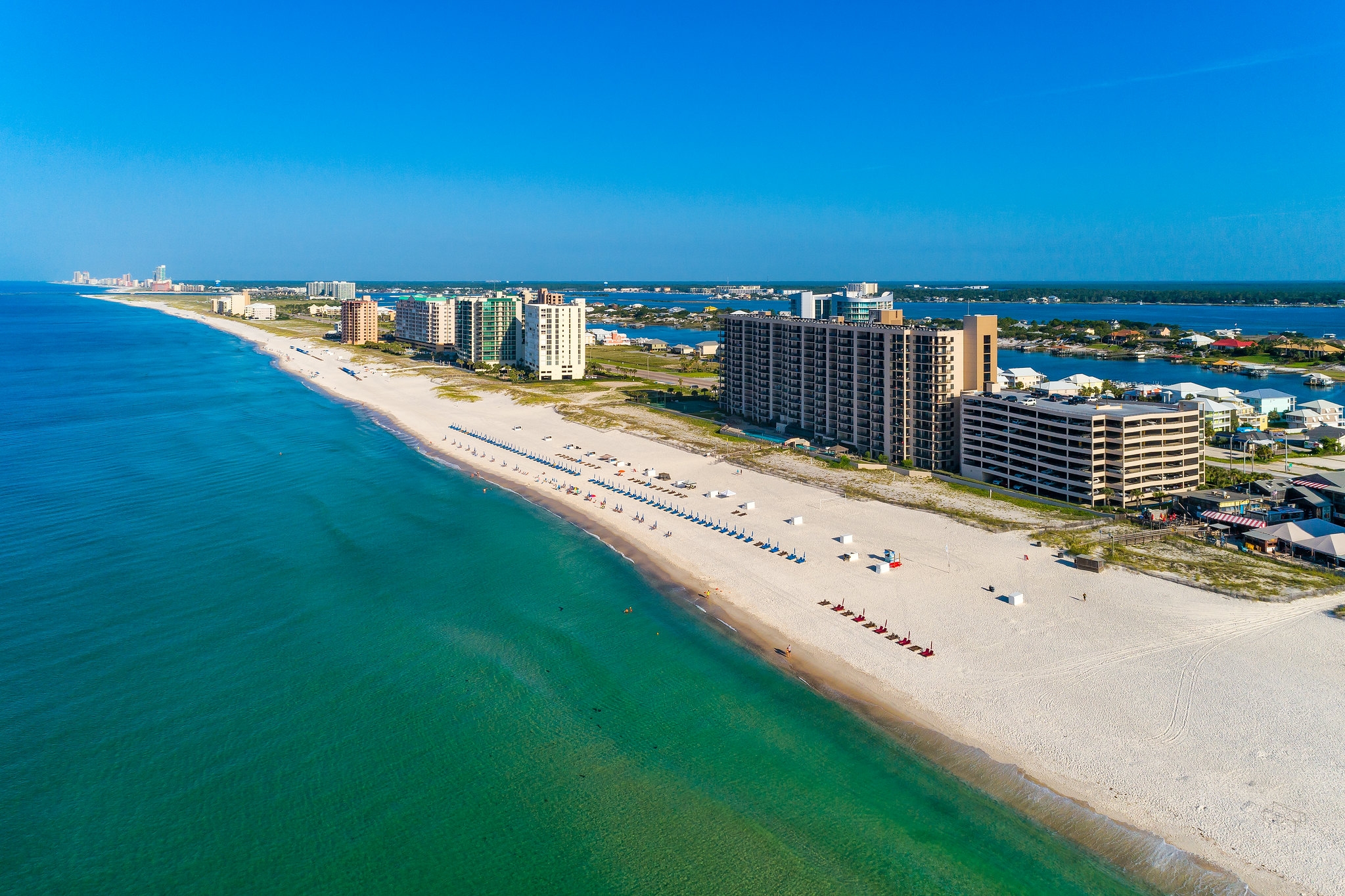 Beautiful Gulf Shores beach with soft waves and clear skies