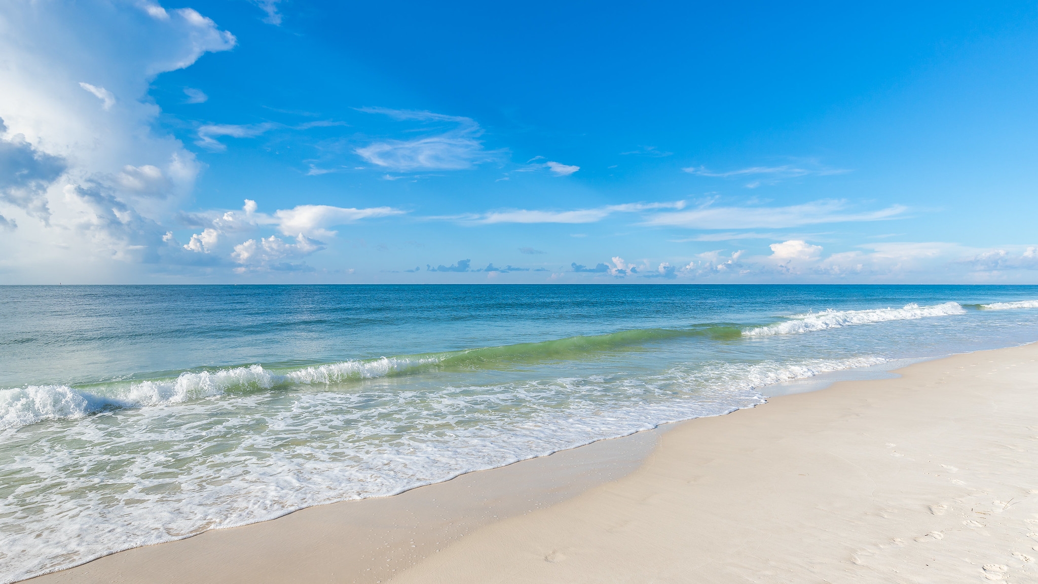 Waves beside white sand