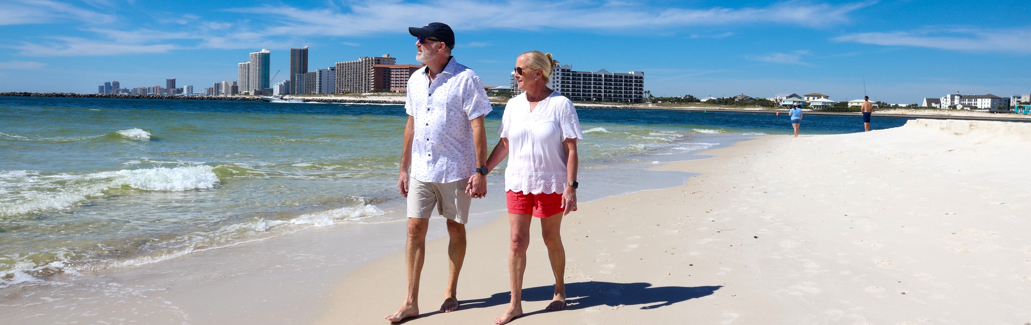A couple walking along the shore