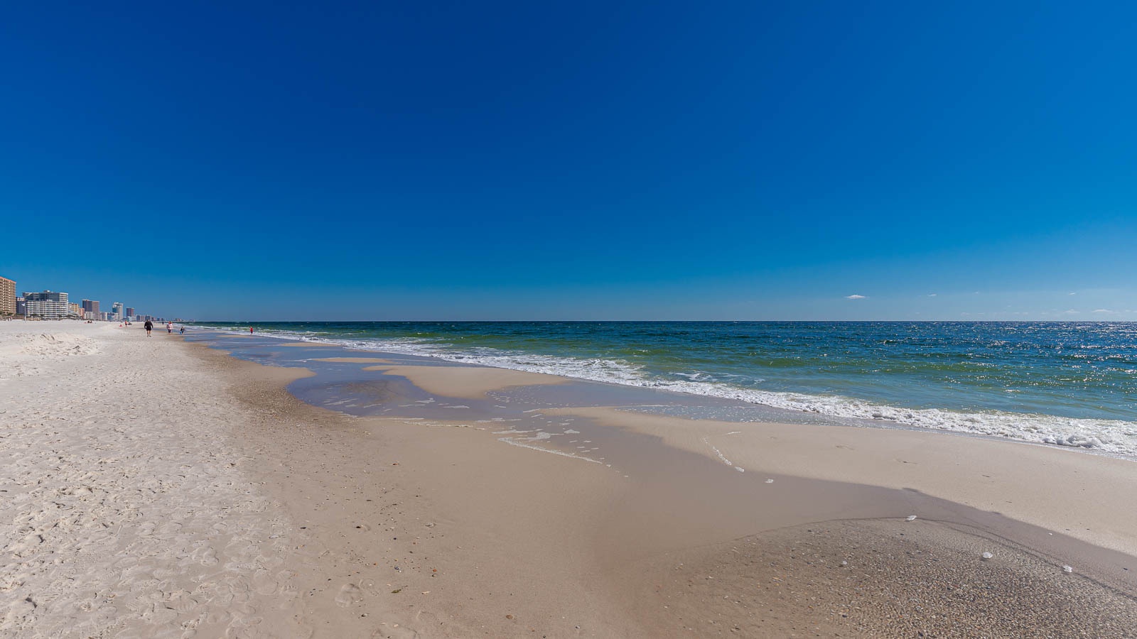 Wide white-sand beach in Orange Beach