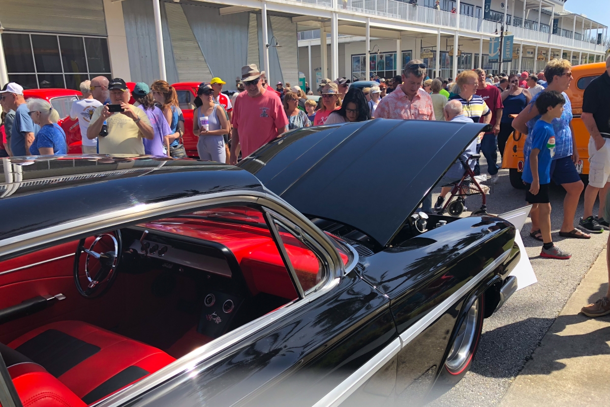 Visitors viewing a classic car at the festival