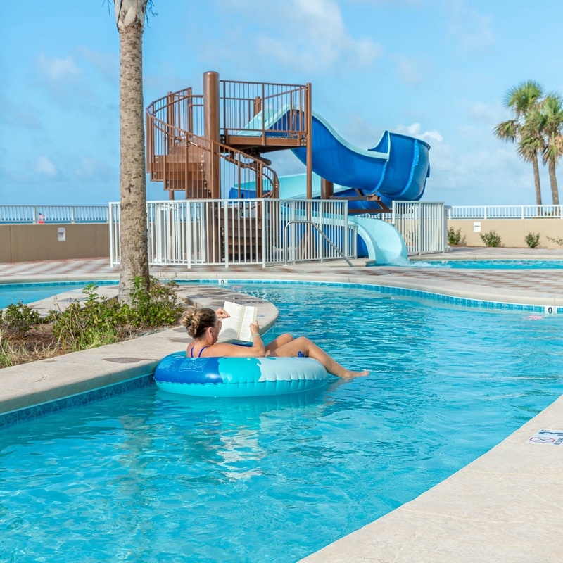 Lazy river lined with palm trees at Phoenix Orange Beach II