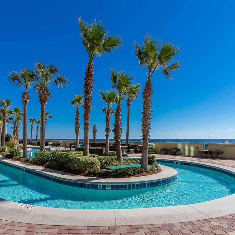Lazy river surrounded by palm trees steps from the beach