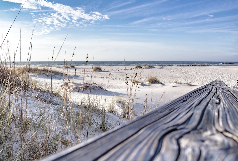 Beachfront pool and lounge chairs overlooking the Gulf at a Brett/Robinson property in Orange Beach
