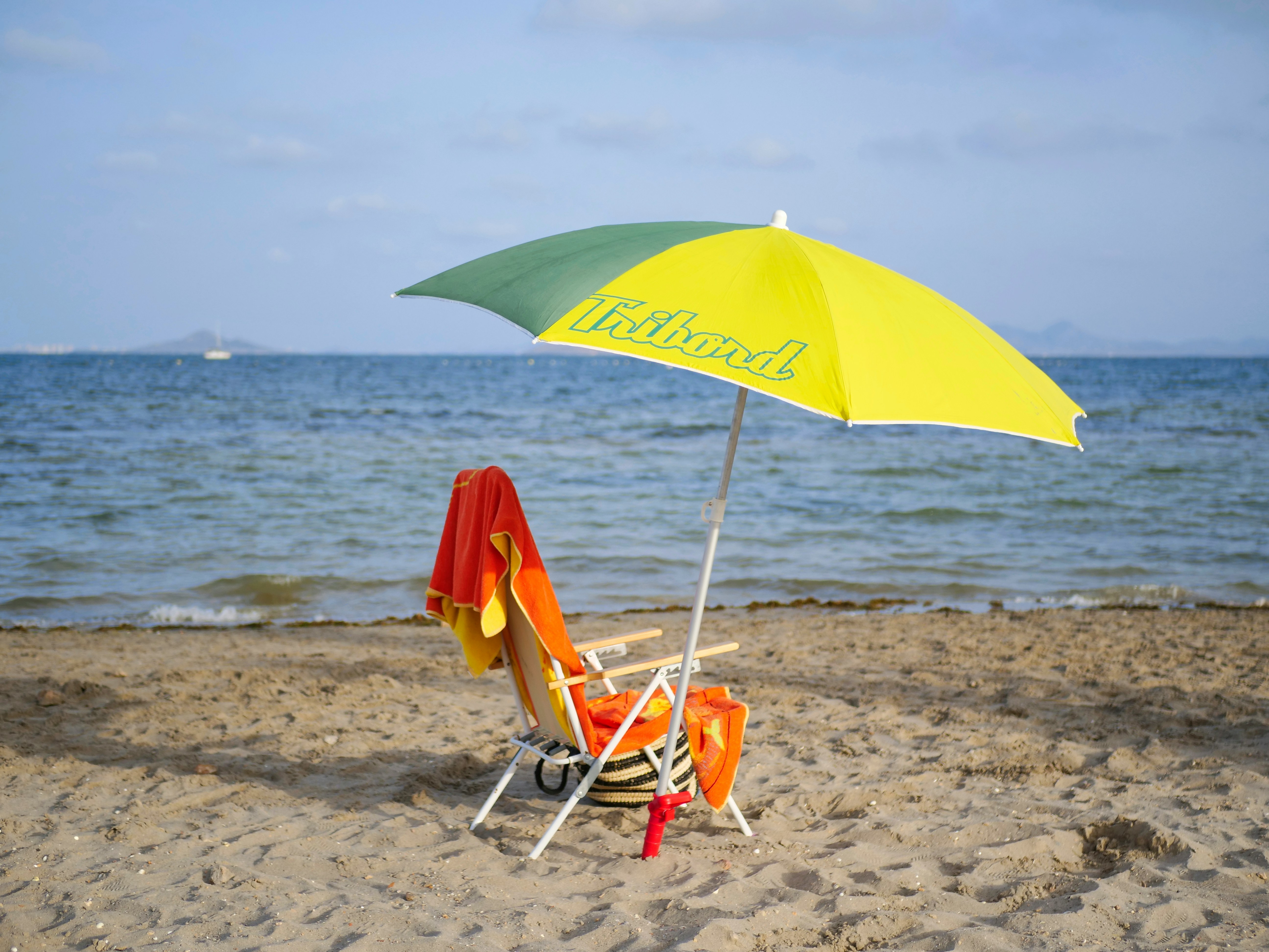 Beach chairs, umbrella, and cooler setup